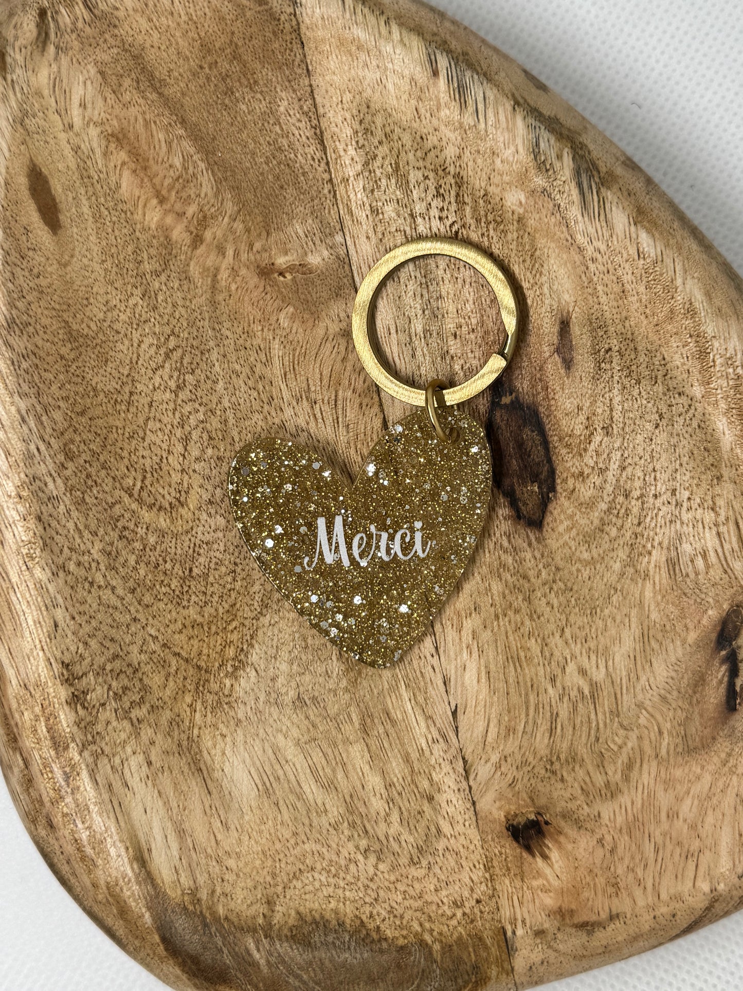 Porte-clés cœur pailleté doré “Merci”