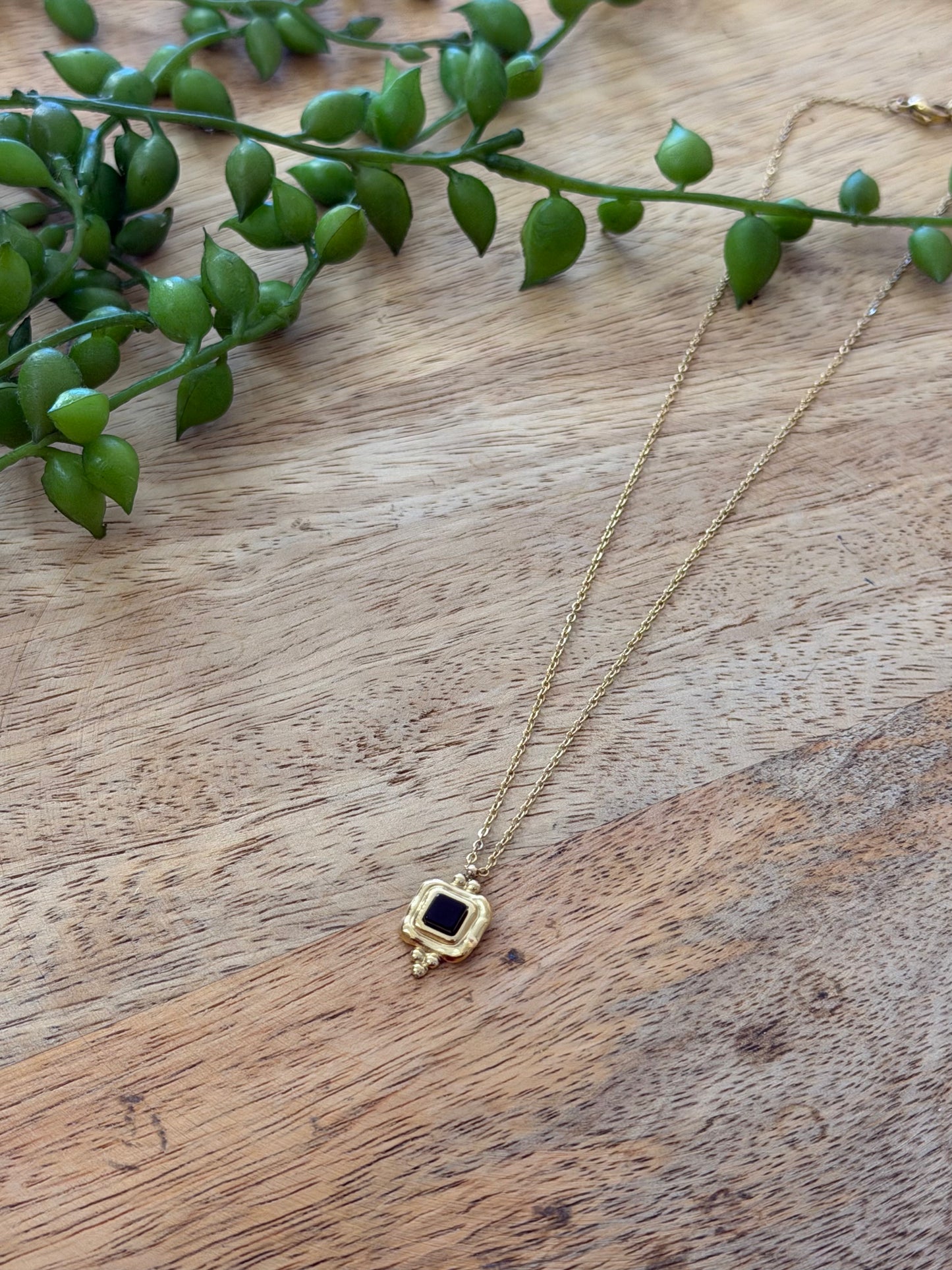 Collier doré pendentif noir