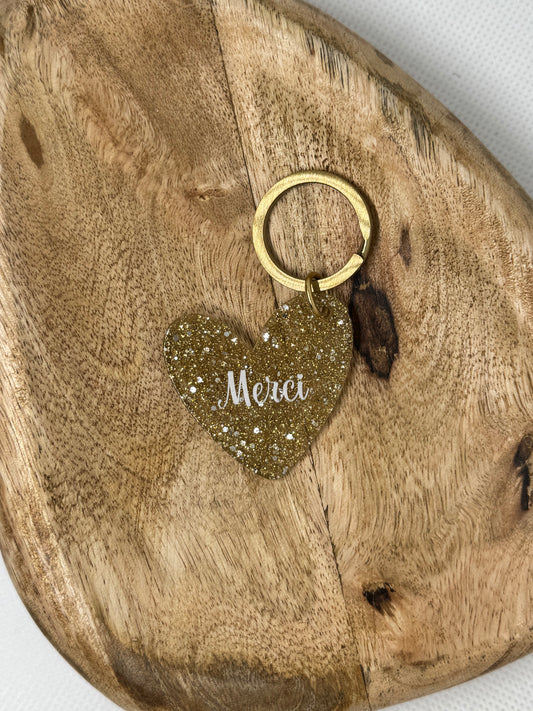 Porte-clés cœur pailleté doré “Merci”